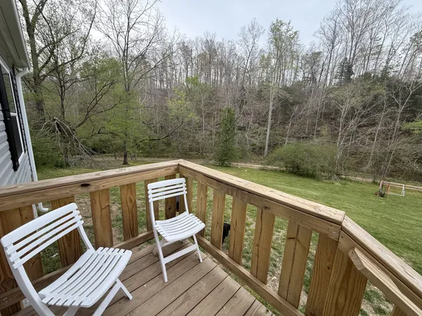 a view of a balcony with wooden floor and outdoor seating