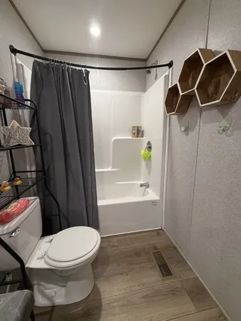 a bathroom with a toilet and shower