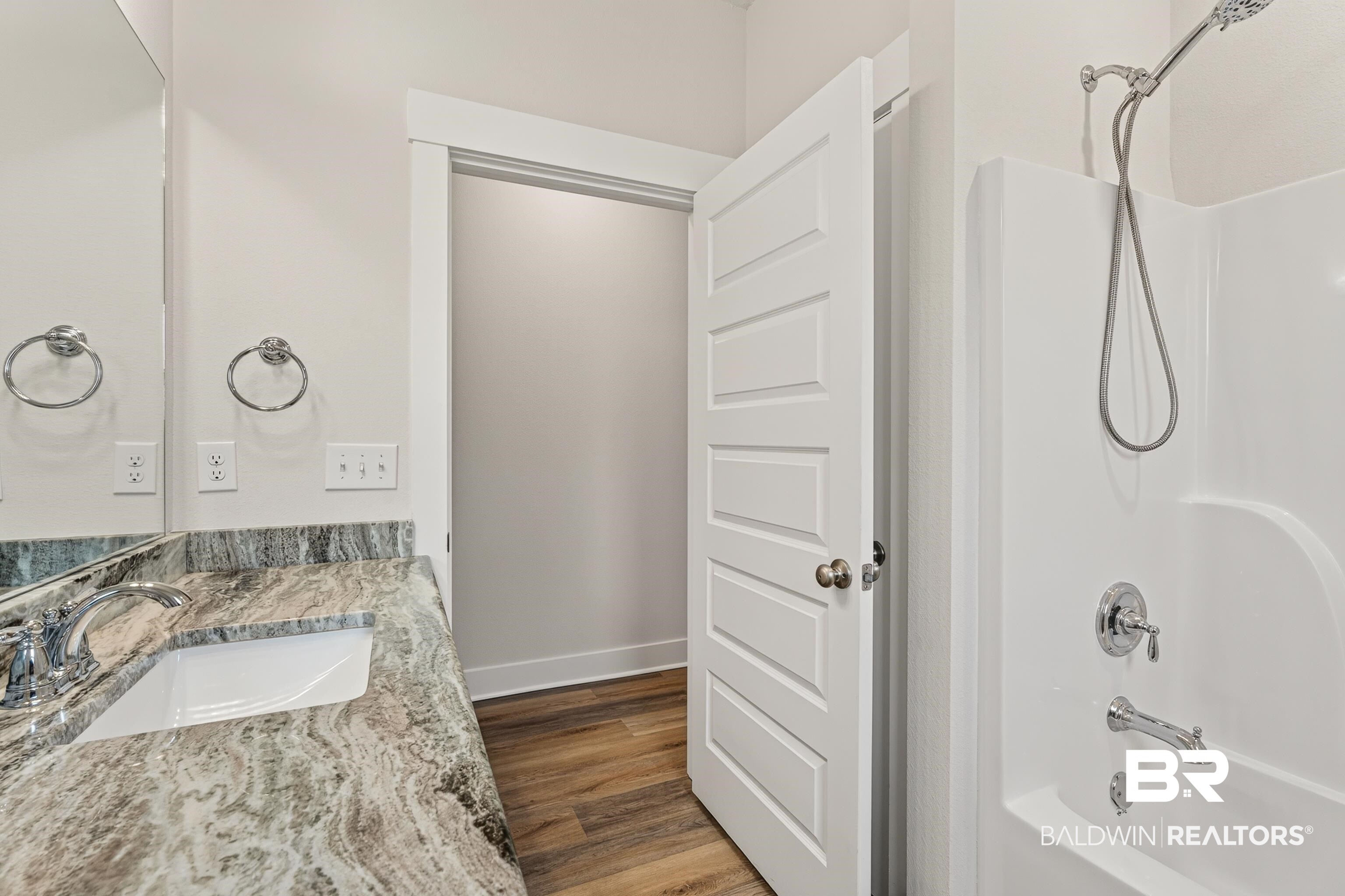 1724 Partridge Street Foley, AL 36535 - Photo 39 of 62 Bathroom vanity featuring a polished chrome faucet, under-mount sink, and a stone countertop