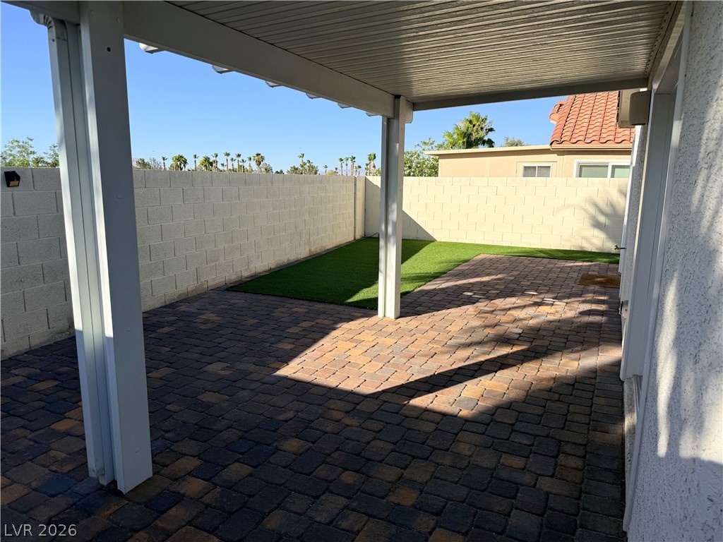 2122 Hidden Ranch Terrace Henderson, NV 89052 - Photo 19 of 20 A well-maintained outdoor space with paver flooring, synthetic turf, and a covered patio.