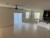 a view of a room with gym equipment and a large window