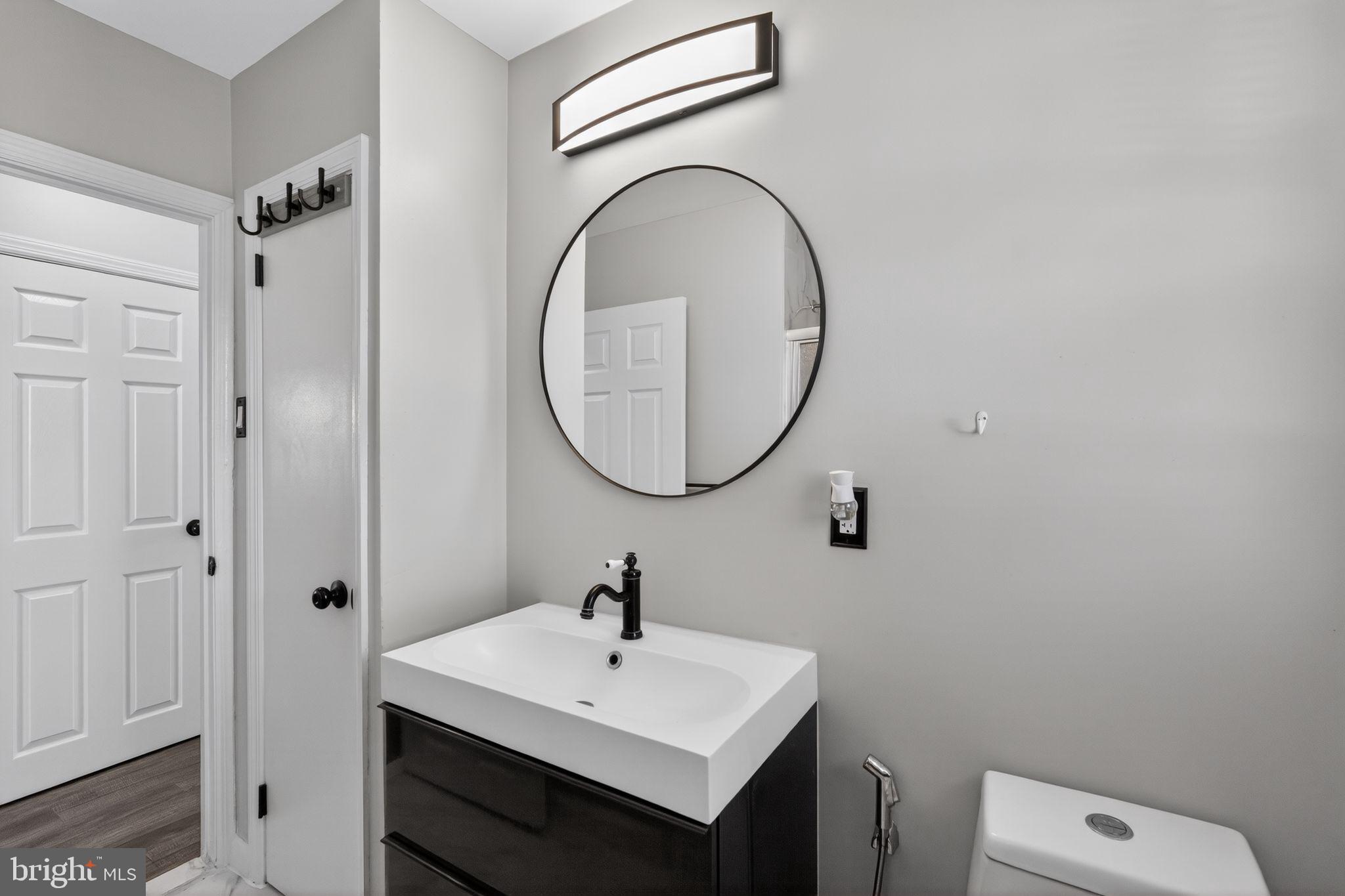 110 McCormick Avenue Ridley Park, PA 19078 - Photo 25 of 29 a bathroom with a sink a toilet and a mirror
