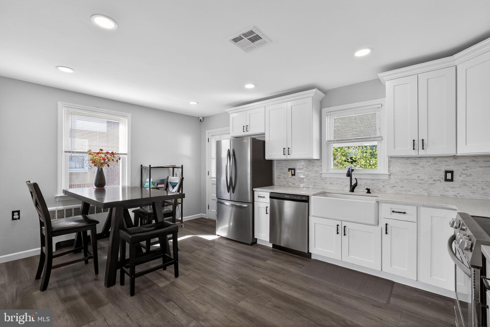 110 McCormick Avenue Ridley Park, PA 19078 - Photo 7 of 29 a kitchen with stainless steel appliances a dining table chairs microwave and sink