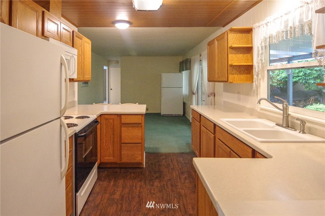 3309 206th Place Southeast Bothell, WA 98012 - Photo 11 of 32 a kitchen with a sink a stove and a refrigerator