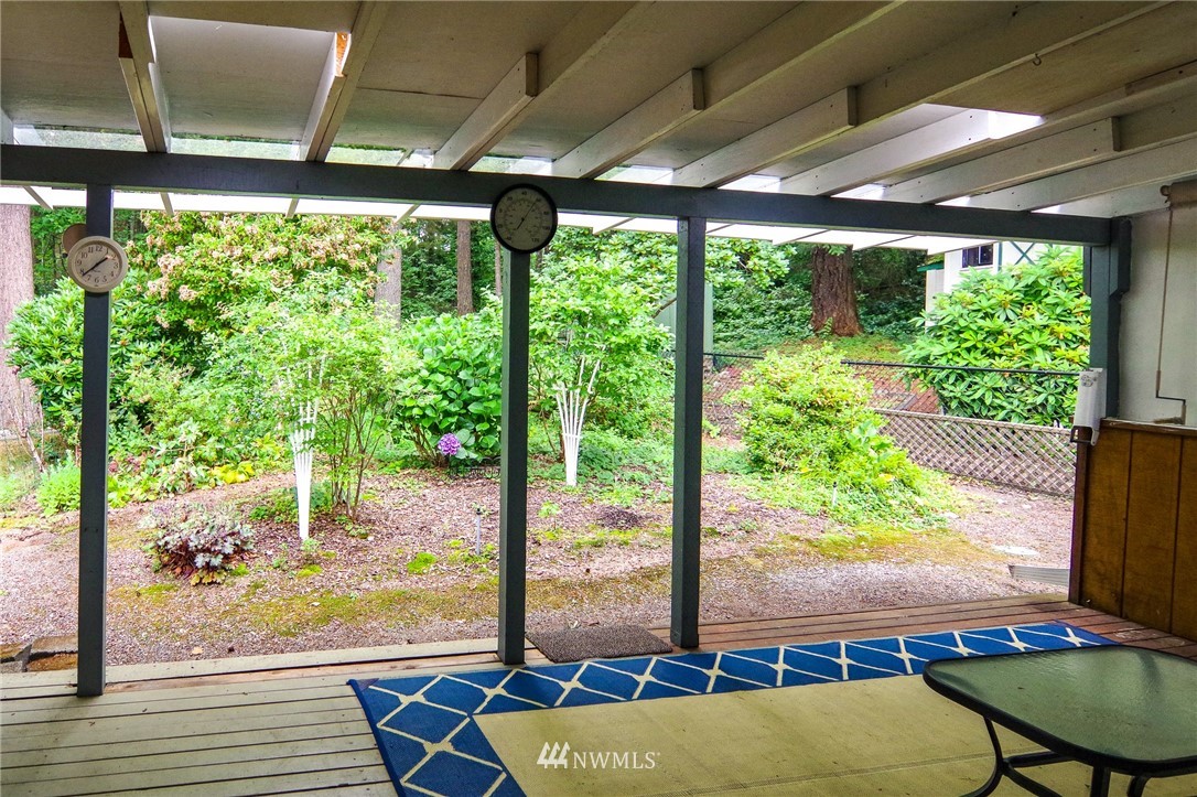 3309 206th Place Southeast Bothell, WA 98012 - Photo 15 of 32 a view of a patio with table and chairs and floor to ceiling window with garden view