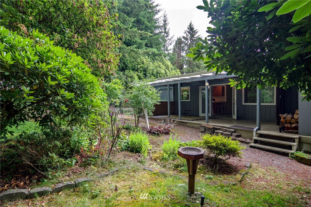 3309 206th Place Southeast Bothell, WA 98012 - Photo 17 of 32 a view of a house with backyard sitting area and garden