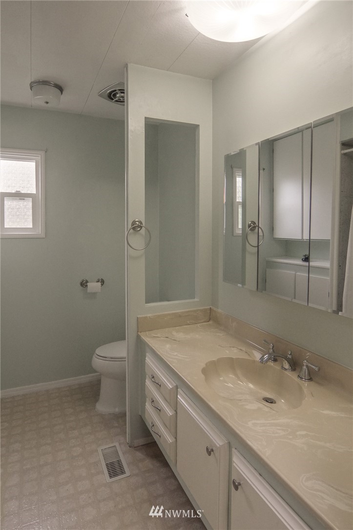 3309 206th Place Southeast Bothell, WA 98012 - Photo 19 of 32 a bathroom with a granite countertop sink toilet and shower