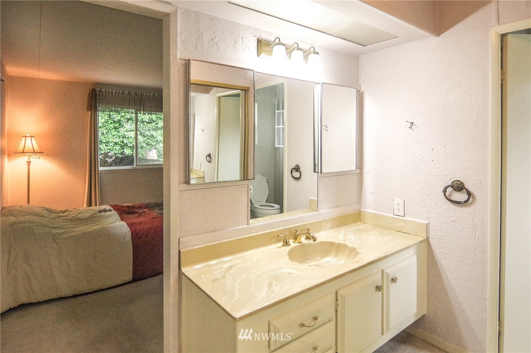 3309 206th Place Southeast Bothell, WA 98012 - Photo 24 of 32 a en suite bathroom with a granite countertop sink and a mirror