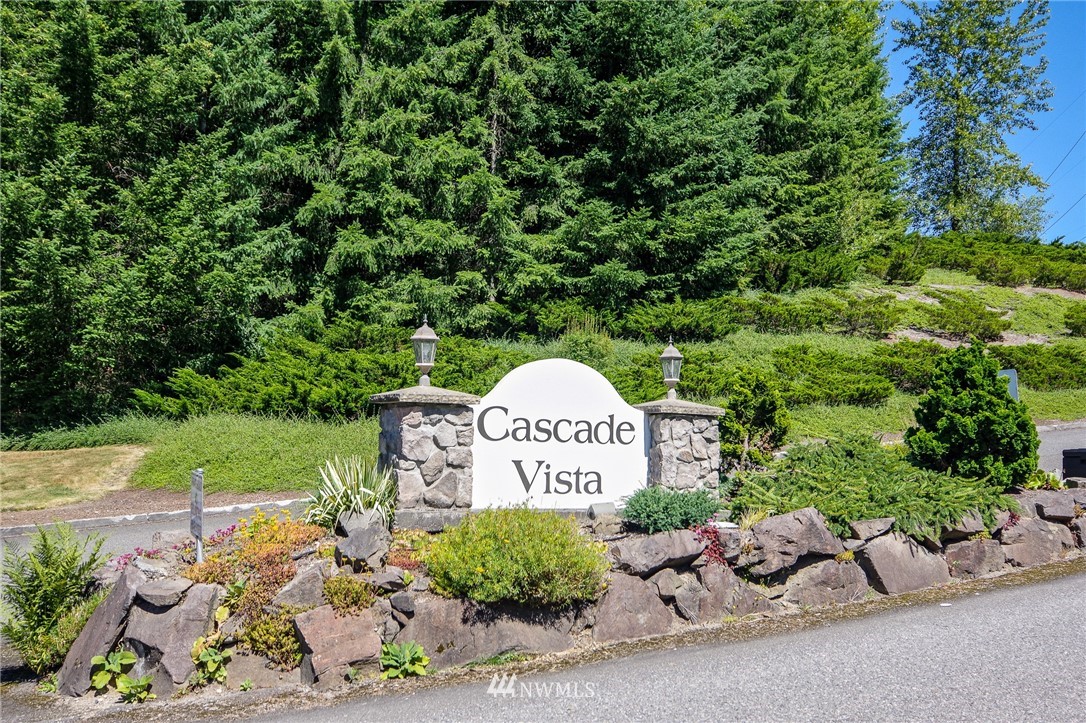 3309 206th Place Southeast Bothell, WA 98012 - Photo 31 of 32 a garden with a bench in front of the house