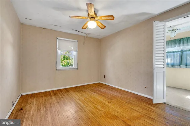 wooden floor in an empty room with a window