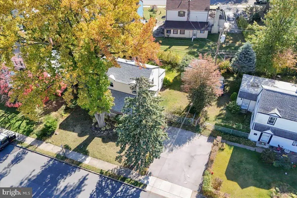 an aerial view of residential houses with yard