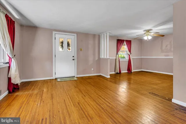a view of an empty room with wooden floor