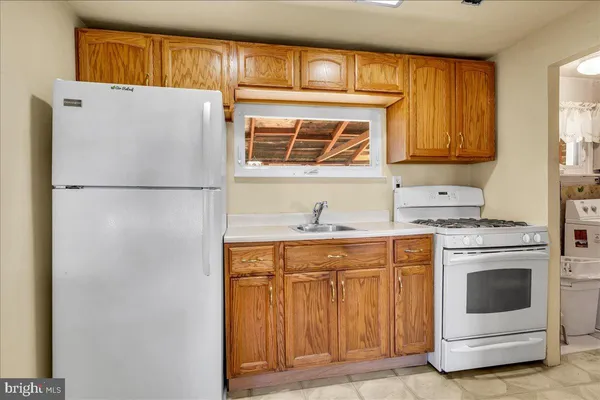 a white refrigerator freezer sitting inside of a kitchen