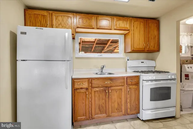 a white refrigerator freezer sitting inside of a kitchen