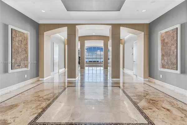 a view of a hallway with wooden floor and a living room