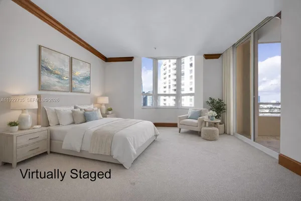 a spacious bedroom with a bed and a large window
