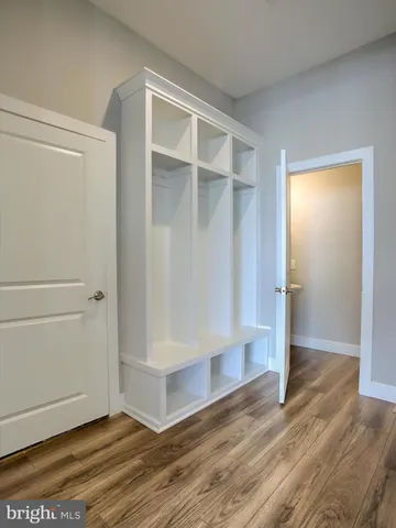 a view of an empty room with wooden floor