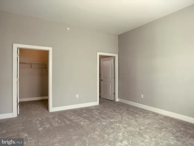 a view of an empty room and closet area