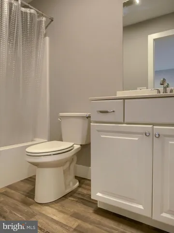 a white toilet sitting next to a bathroom sink