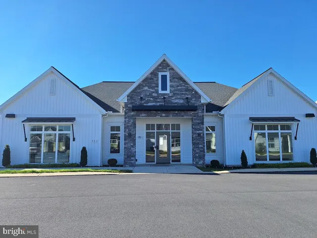 a view of a room with gym equipment and a flat screen tv