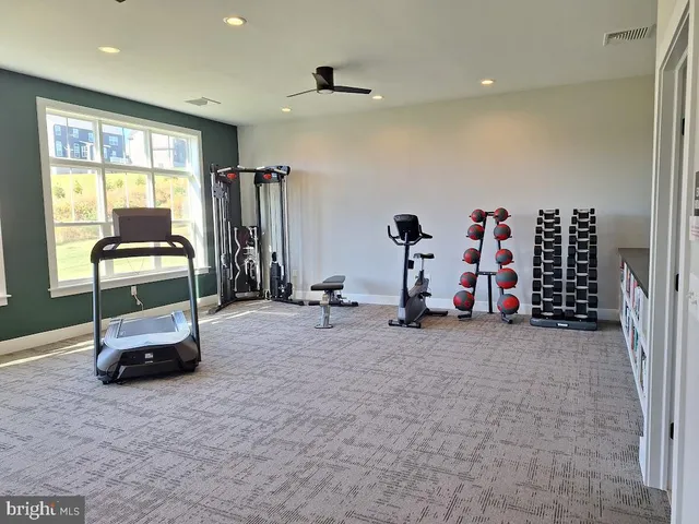a view of a bedroom with baby crib and lounge chair