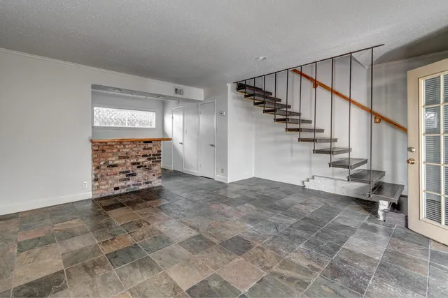 an empty room with wooden floor and a window