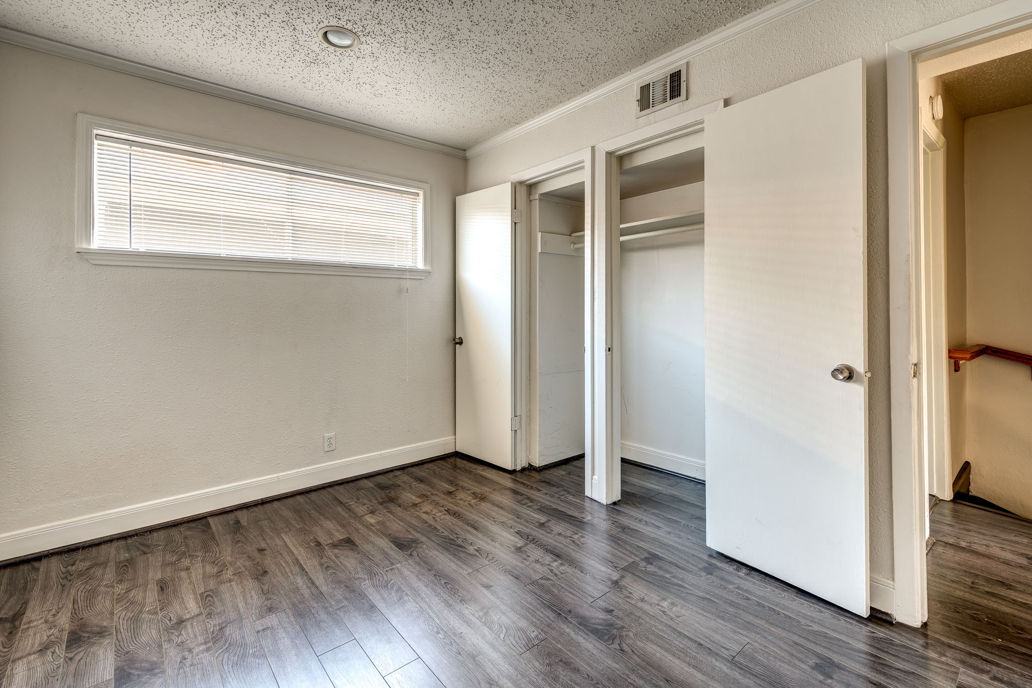 4321 Hazard Street, Unit 9 Houston, TX 77098 - Photo 3 of 8 an empty room with wooden floor and a window