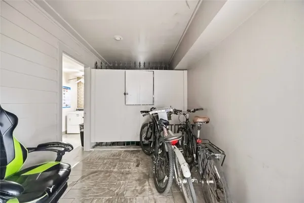 a room with gym equipment and potted plant