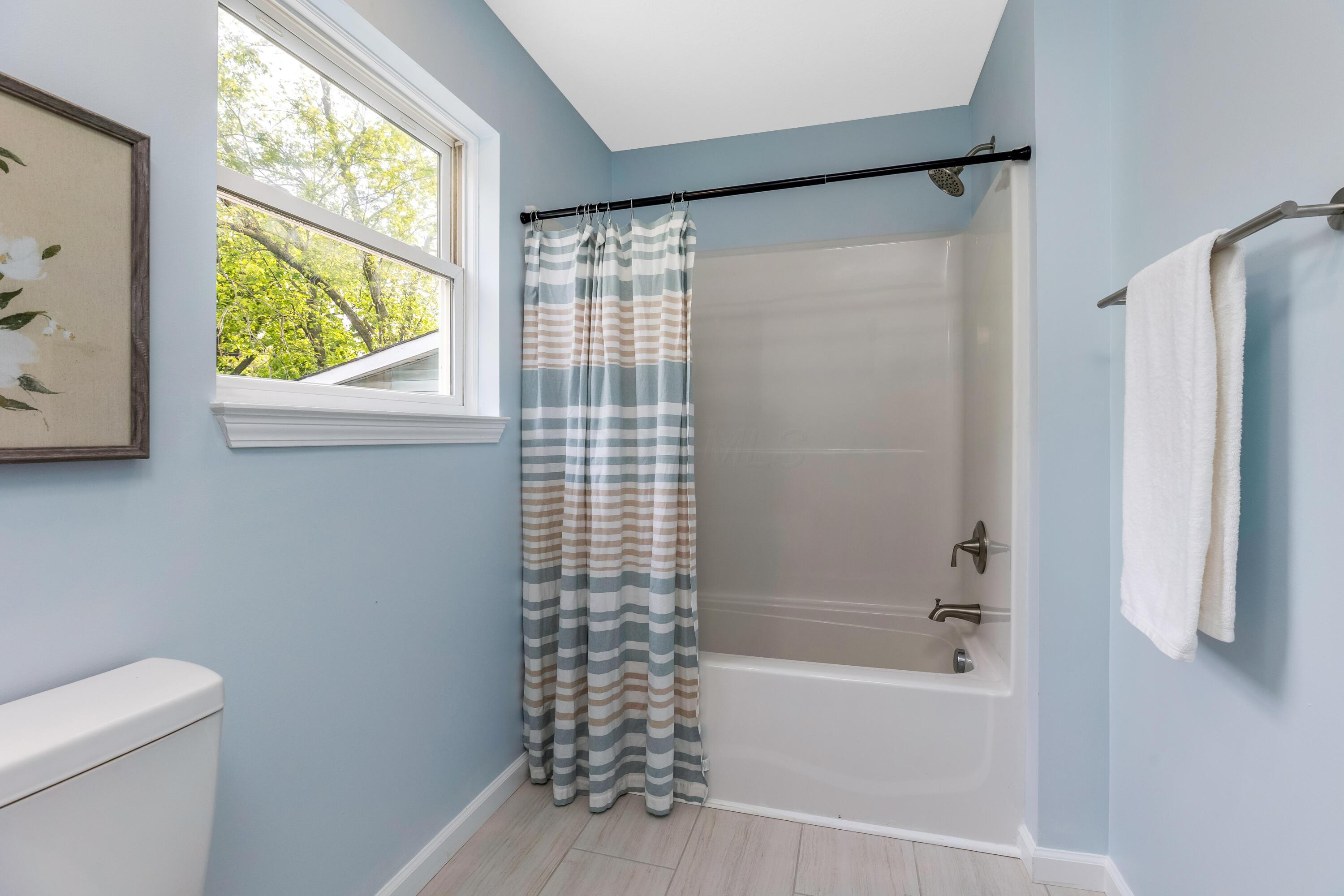 225 Reeb Avenue Columbus, OH 43207 - Photo 28 of 46 This is IRL Staging I don't know why we put a shower curtain on this one and not the other one. Also this is the only room we didn't put blinds up.