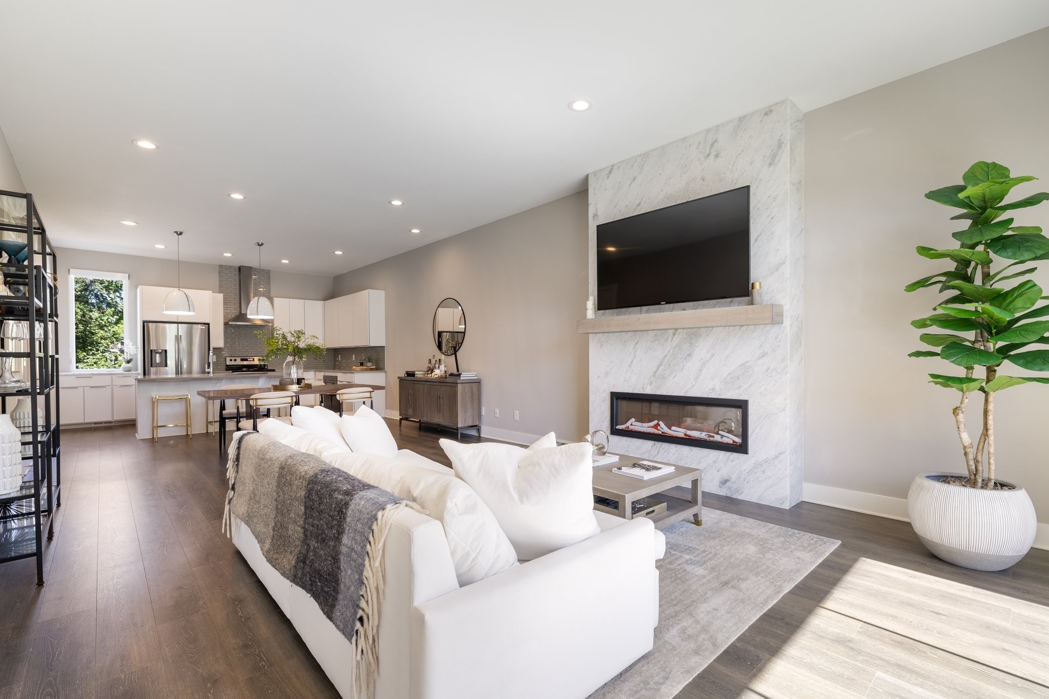 a living room with furniture a fireplace and a flat screen tv