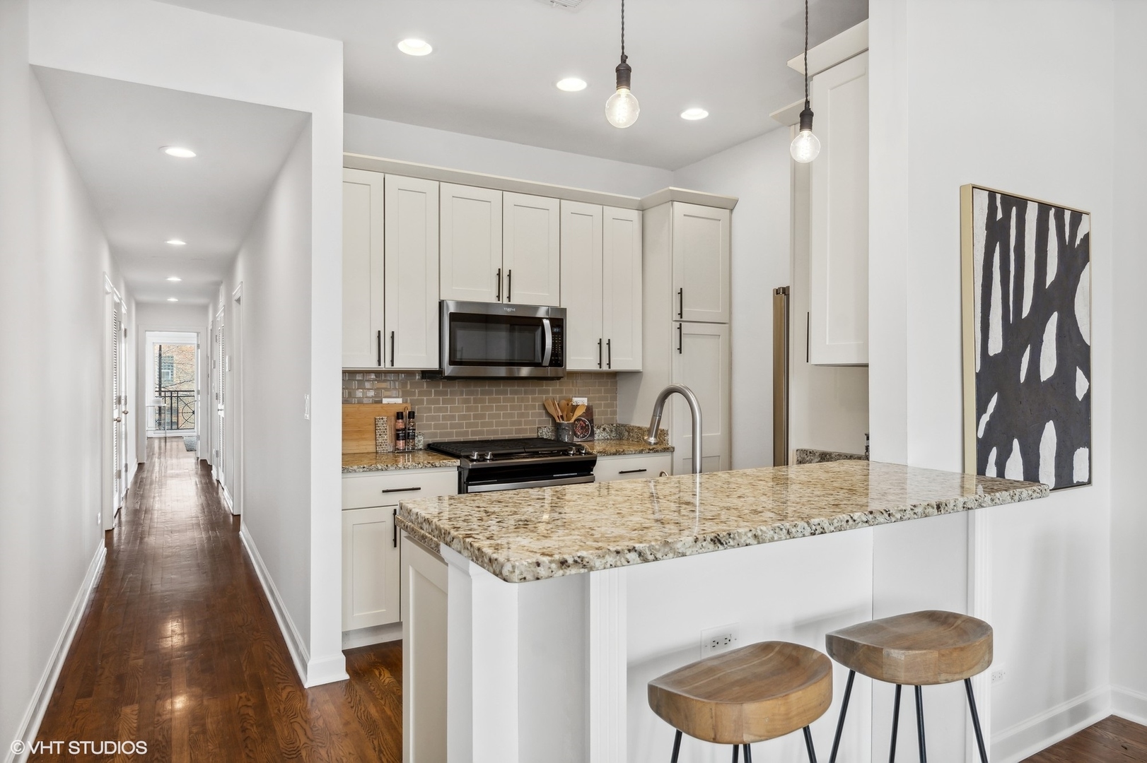 2130 West Rice Street, Unit 3 Chicago, IL 60622 - Photo 6 of 18 a kitchen with stainless steel appliances granite countertop a stove top oven a sink dishwasher and a refrigerator