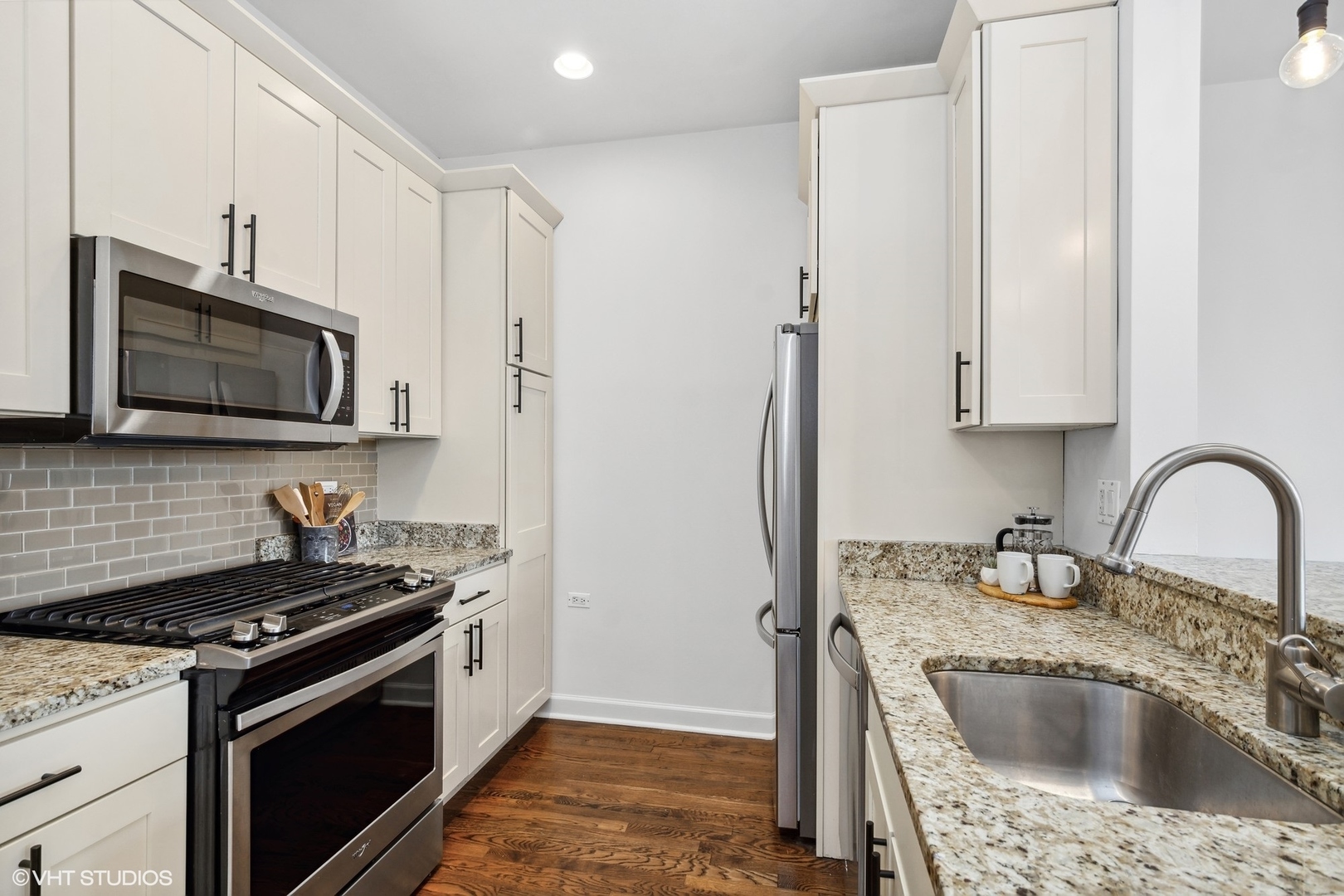 2130 West Rice Street, Unit 3 Chicago, IL 60622 - Photo 7 of 18 a kitchen with stainless steel appliances granite countertop a stove a sink and a microwave