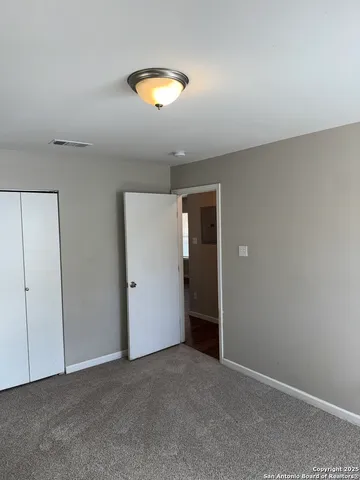 a view of an empty room and a window