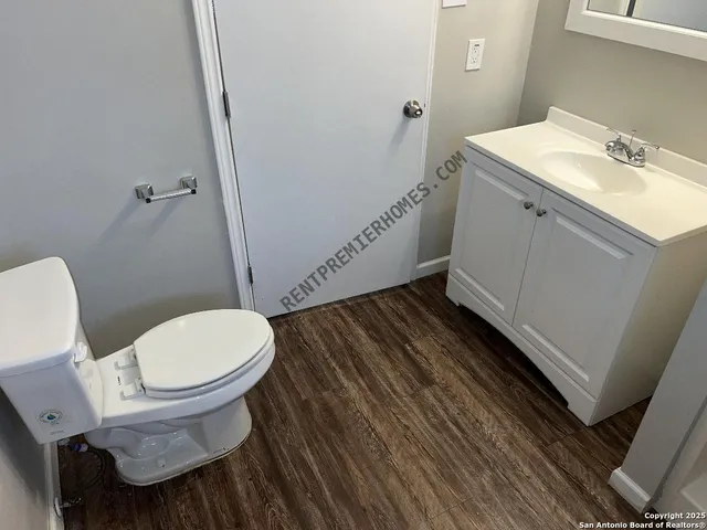 a white toilet sitting next to a bathroom sink
