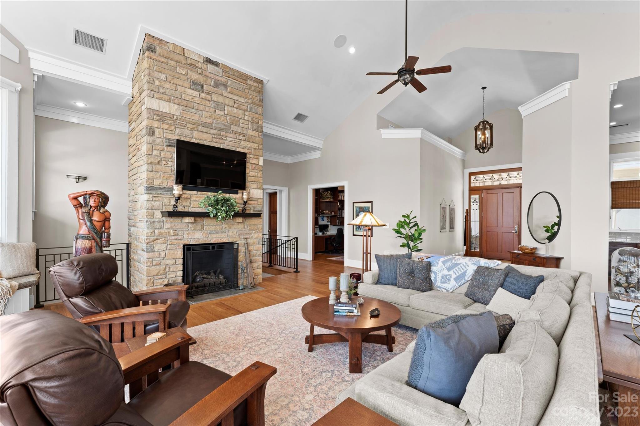 101 Island Ridge Drive Statesville, NC 28677 - Photo 12 of 48 a living room with furniture a fireplace and a flat screen tv