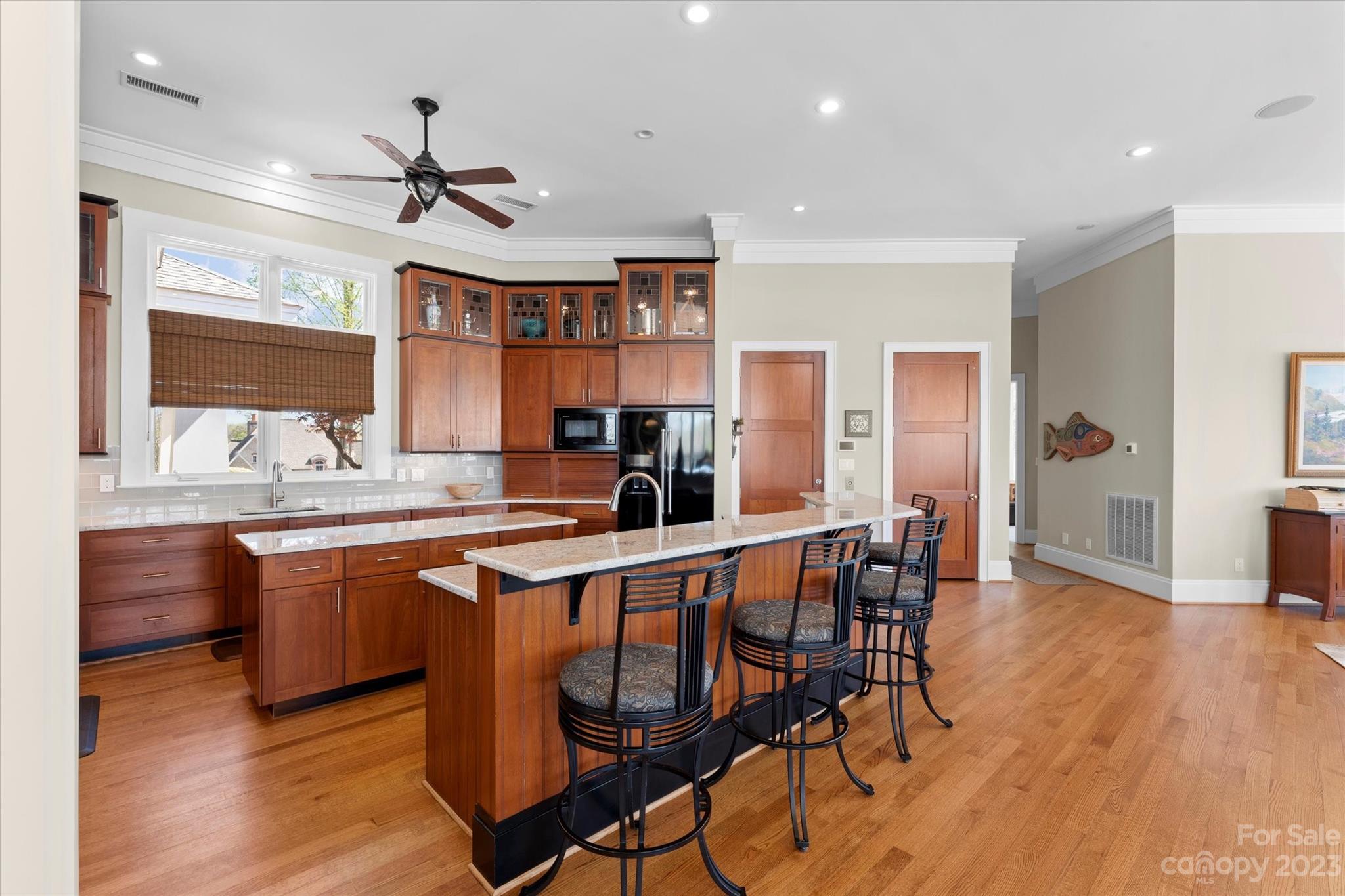 101 Island Ridge Drive Statesville, NC 28677 - Photo 16 of 48 a kitchen with stainless steel appliances granite countertop a table chairs sink and wooden floor