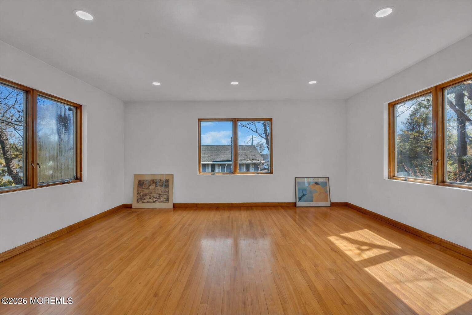 608 Rankin Road Brielle, NJ 08730 - Photo 16 of 27 a view of an empty room with a window and wooden floor