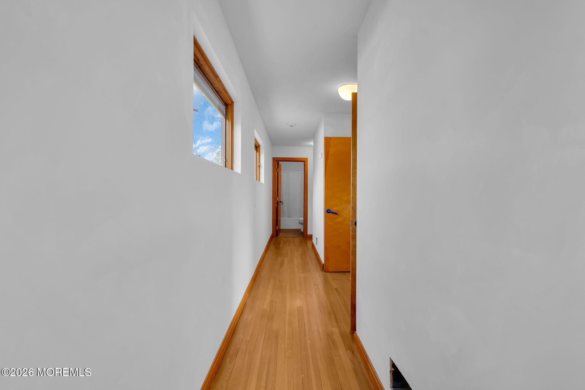 608 Rankin Road Brielle, NJ 08730 - Photo 17 of 27 a view of a hallway with wooden floor and staircase