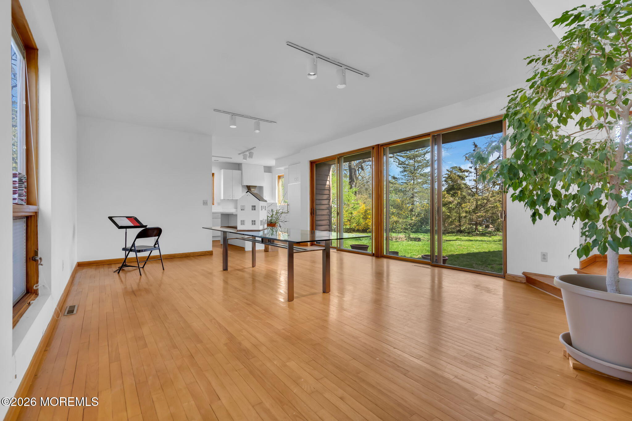 608 Rankin Road Brielle, NJ 08730 - Photo 9 of 27 a view of an empty room with wooden floor and a yard