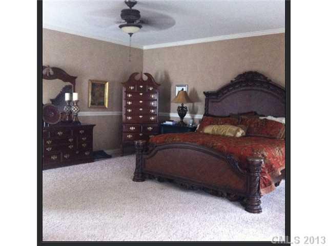 3580 Dobys Bridge Road Fort Mill, SC 29715 - Photo 7 of 15 a bedroom with a bed and a chandelier