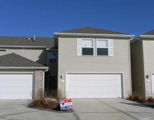 25161 Faraday Road, Unit 2 Manhattan, IL 60442 - Photo 1 of 1 a front view of a house with a parking space