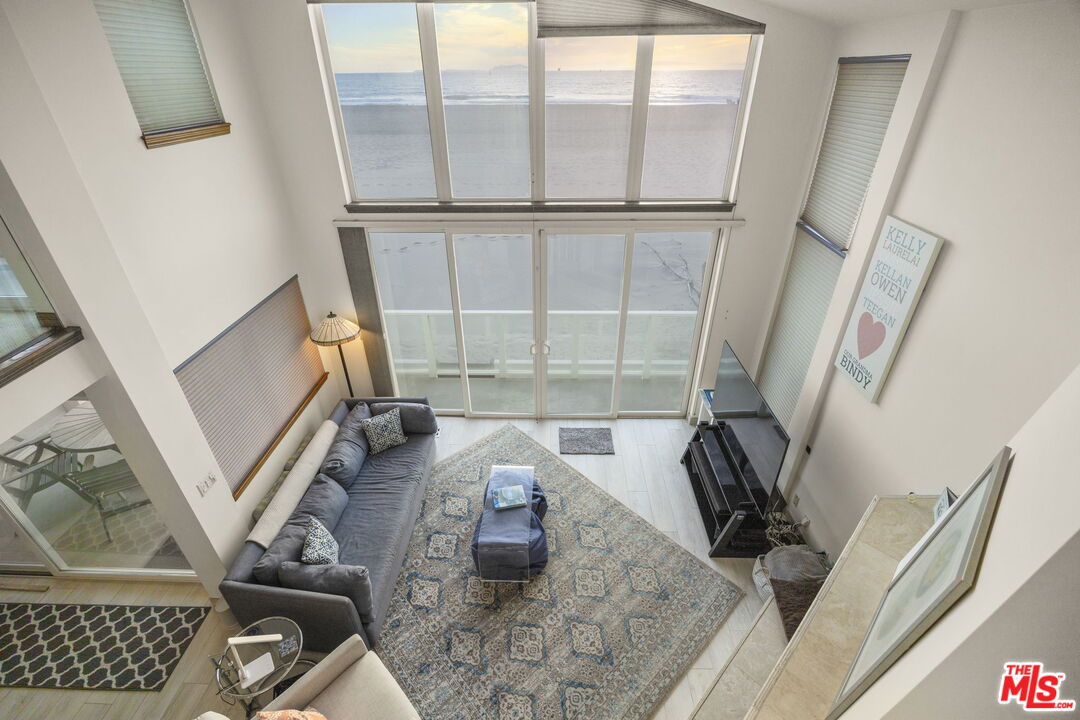 1005 Ocean Drive Oxnard, CA 93035 - Photo 13 of 56 a view of living room with furniture and a floor to ceiling window