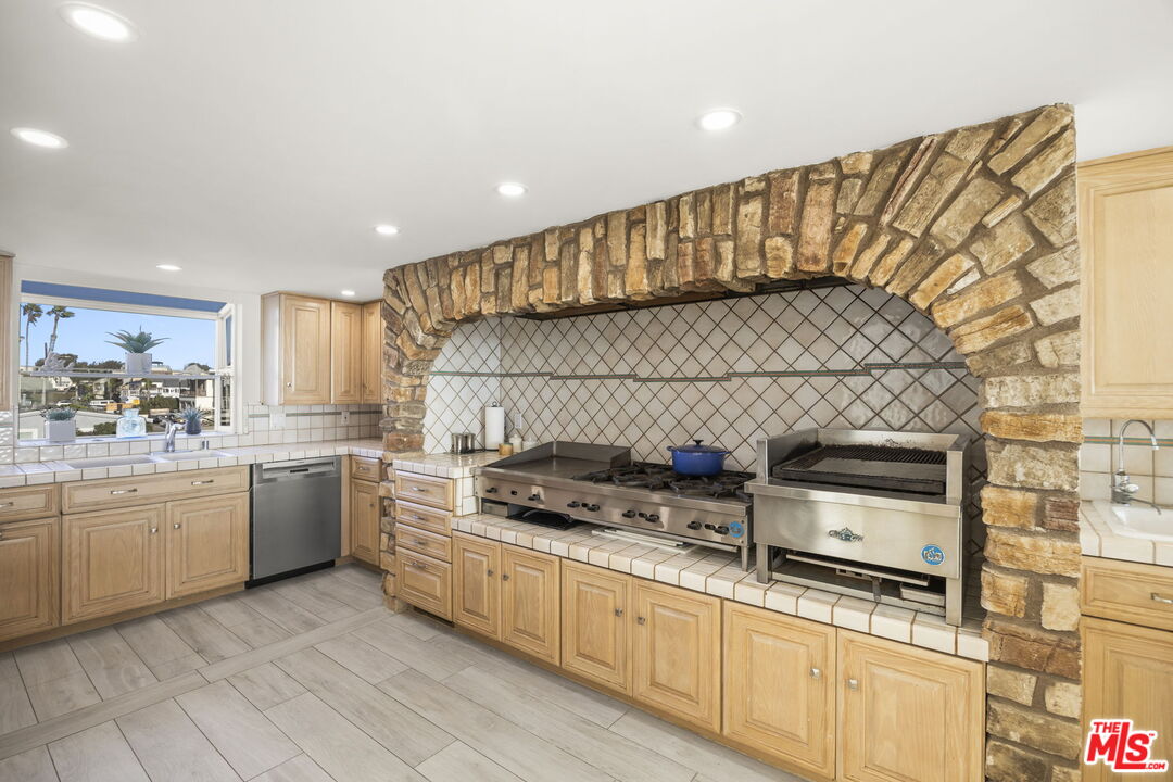 1005 Ocean Drive Oxnard, CA 93035 - Photo 30 of 56 a kitchen with a sink and cabinets