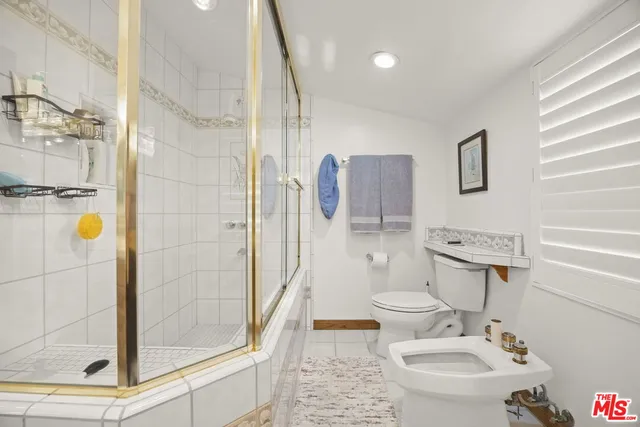 a bedroom with a balcony a bed and a chandelier