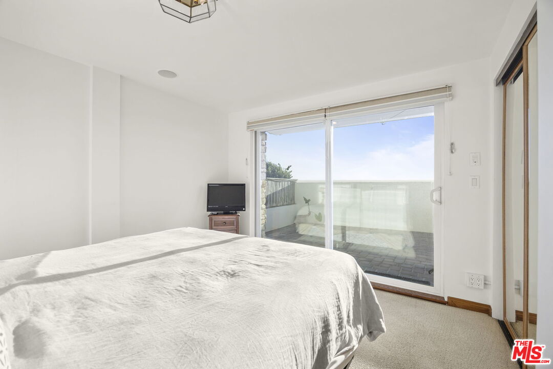 1005 Ocean Drive Oxnard, CA 93035 - Photo 36 of 56 a bedroom with a bed and a window