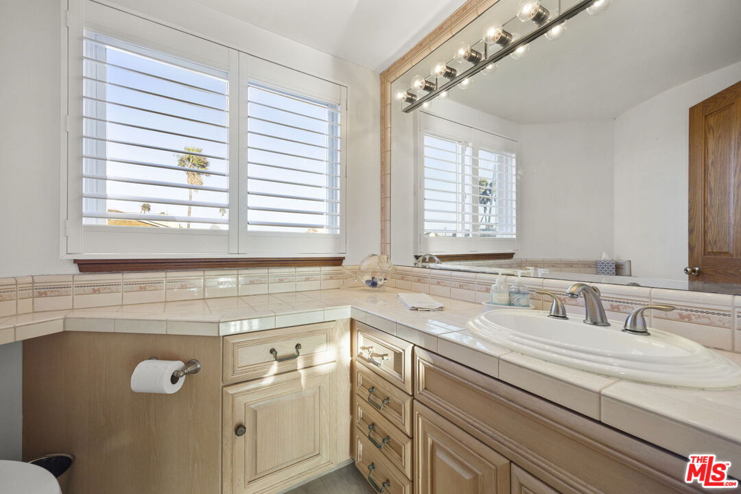 1005 Ocean Drive Oxnard, CA 93035 - Photo 37 of 56 a bathroom with a sink and a window