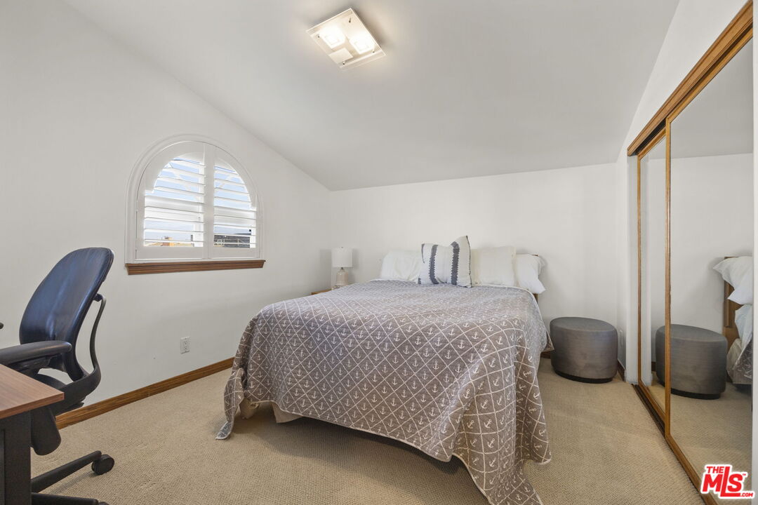 1005 Ocean Drive Oxnard, CA 93035 - Photo 41 of 56 a bedroom with a bed chair and a window