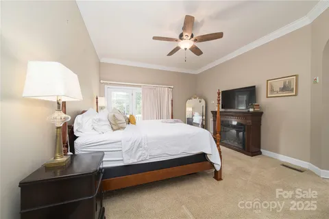 a bedroom with a bed and a lamp on dresser