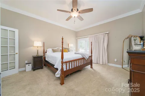 a bedroom with a bed a chandelier and closet