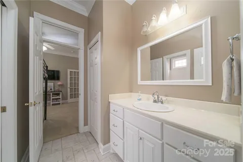 a en suite bathroom with a sink double vanity and mirror